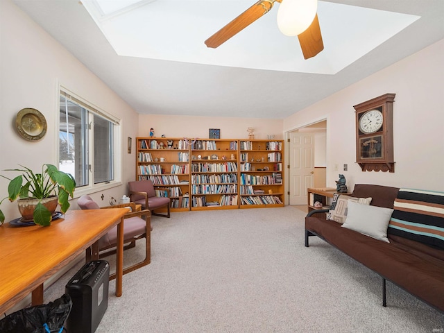 living area with carpet floors and ceiling fan