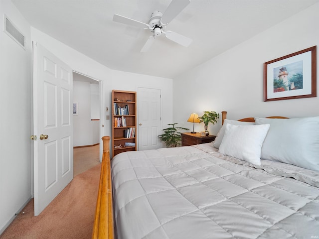 bedroom with ceiling fan and light carpet