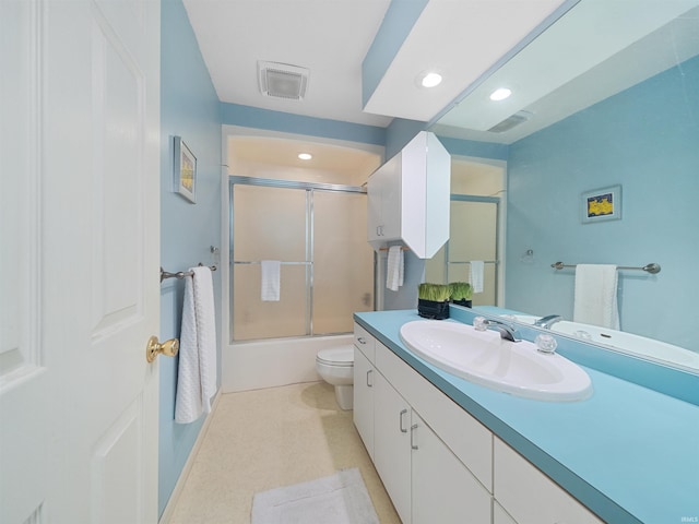 full bathroom featuring shower / bath combination with glass door, vanity, and toilet