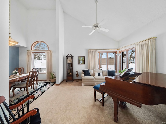 carpeted living room featuring ceiling fan and high vaulted ceiling