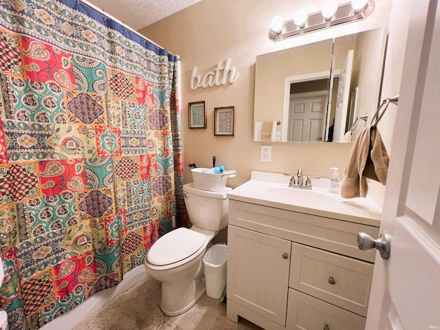 bathroom featuring toilet, tile patterned floors, walk in shower, a textured ceiling, and vanity