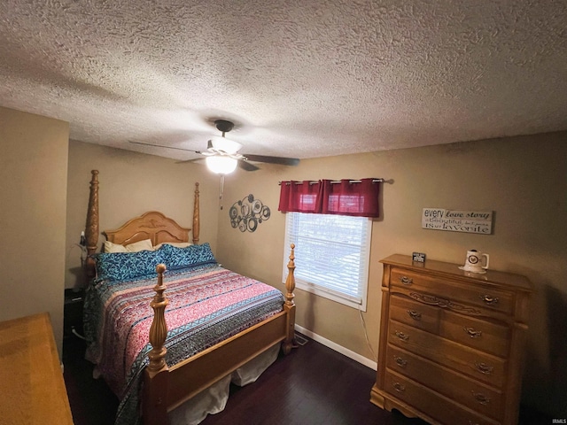 bedroom with ceiling fan, dark wood-type flooring, and a textured ceiling