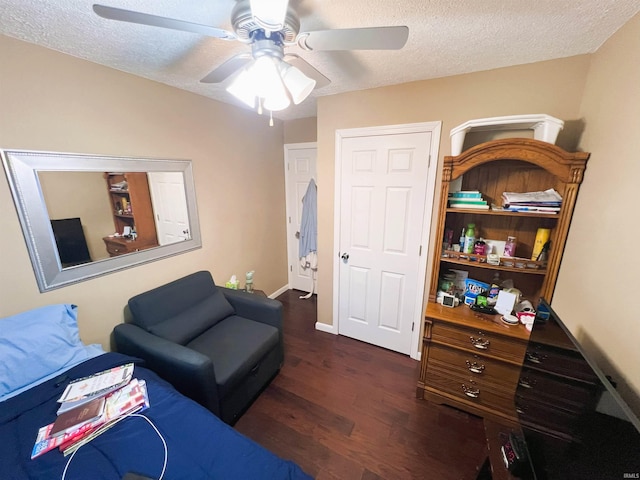 living room featuring a textured ceiling, ceiling fan, and dark hardwood / wood-style flooring