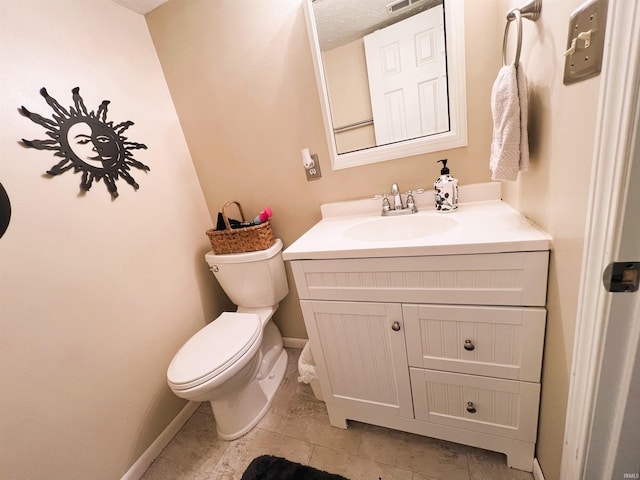 bathroom with toilet and vanity