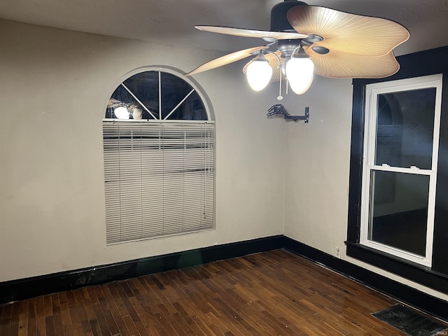 empty room featuring ceiling fan and dark hardwood / wood-style flooring