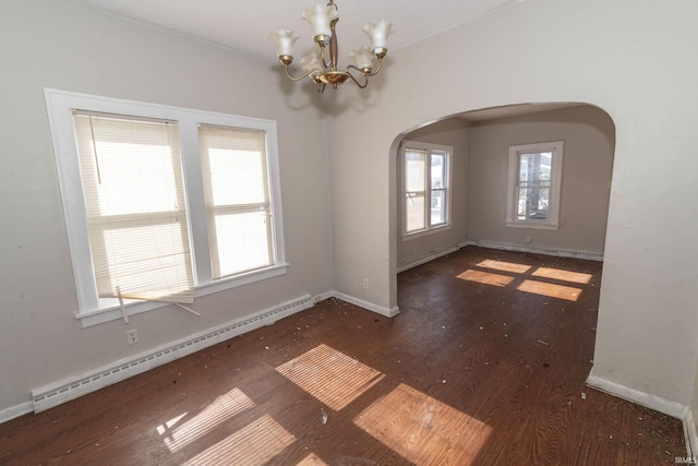 spare room featuring arched walkways, a chandelier, baseboards, baseboard heating, and dark wood-style floors