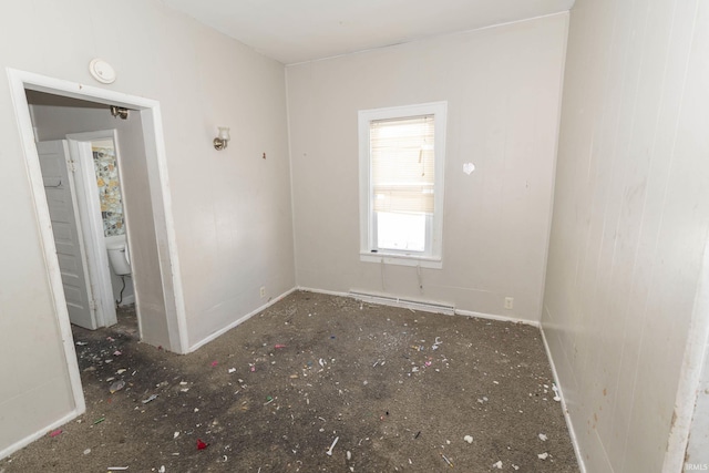 unfurnished room with baseboard heating