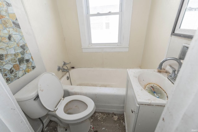 full bathroom with a washtub, vanity, and toilet