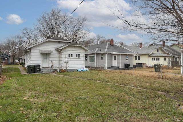 back of house with a yard