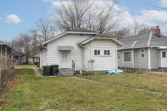 back of property featuring a yard