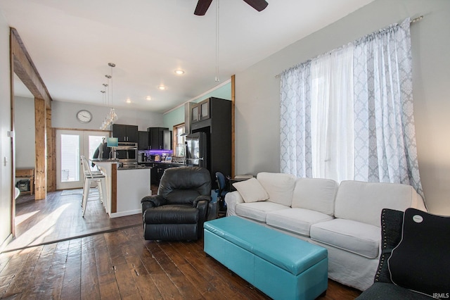 living room with ceiling fan and dark hardwood / wood-style flooring