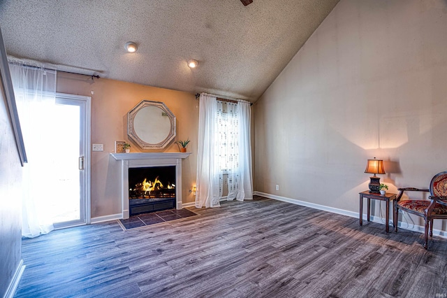 unfurnished living room with a wealth of natural light, vaulted ceiling, dark hardwood / wood-style floors, and a tile fireplace