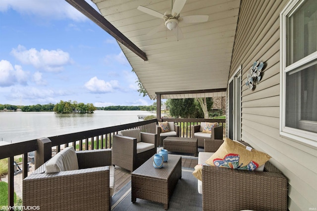 deck featuring ceiling fan, a water view, and outdoor lounge area