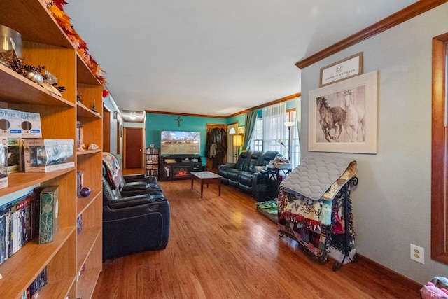 living room featuring wood-type flooring and crown molding