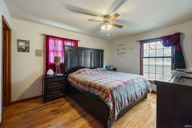 bedroom featuring ceiling fan and light hardwood / wood-style flooring