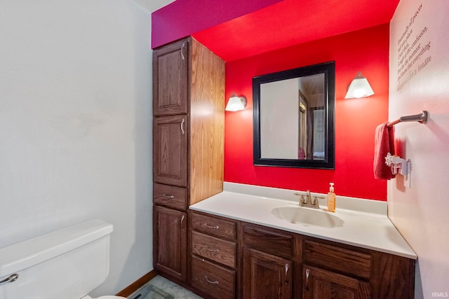 bathroom featuring toilet and vanity