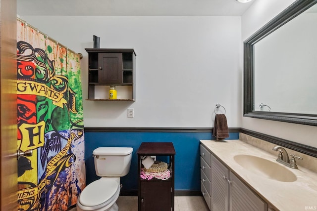 bathroom featuring toilet and vanity