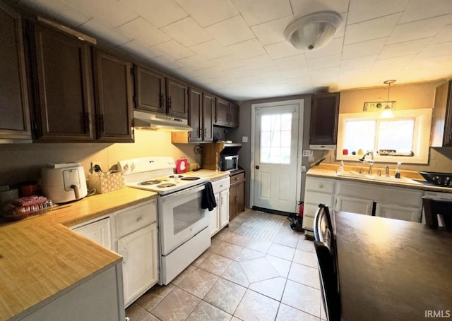 kitchen featuring white range with electric stovetop, pendant lighting, sink, dark brown cabinets, and wood counters