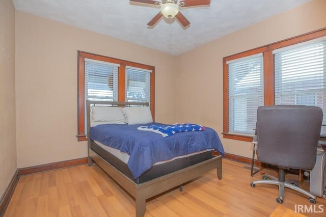 bedroom with ceiling fan and light hardwood / wood-style flooring