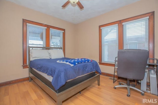 bedroom with light wood-type flooring and ceiling fan