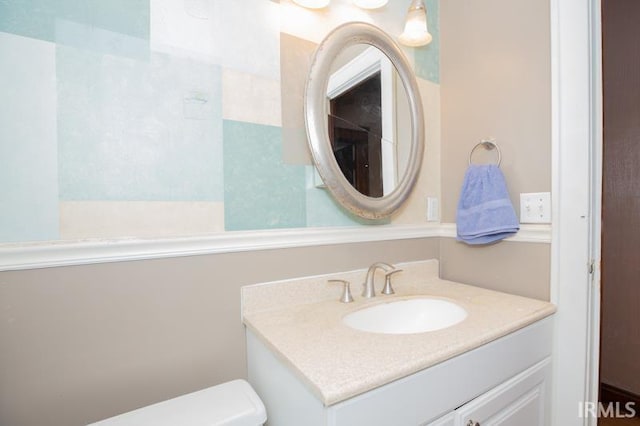 bathroom featuring toilet and vanity