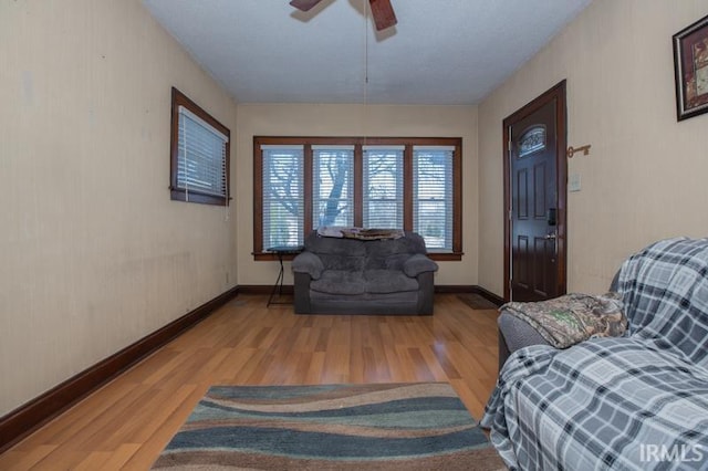 sitting room with ceiling fan and light hardwood / wood-style flooring