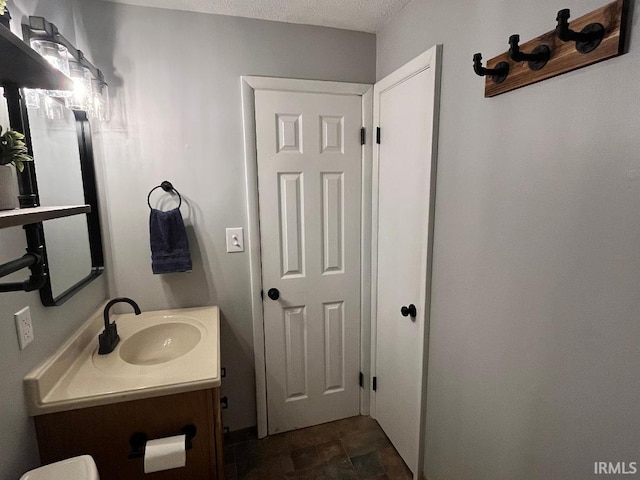 bathroom with vanity and a textured ceiling