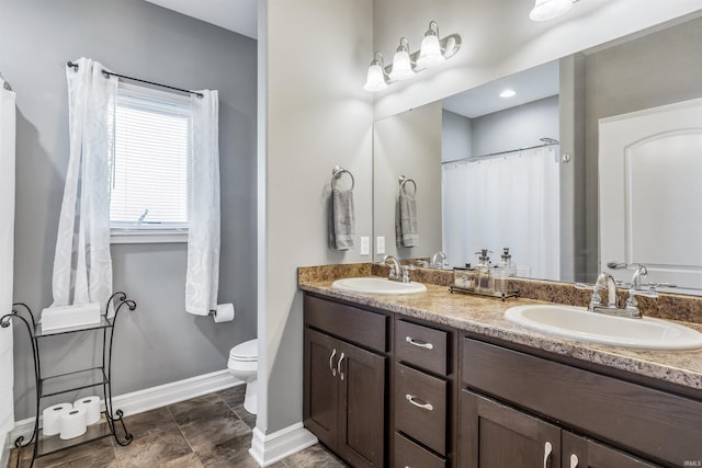 bathroom featuring toilet and vanity