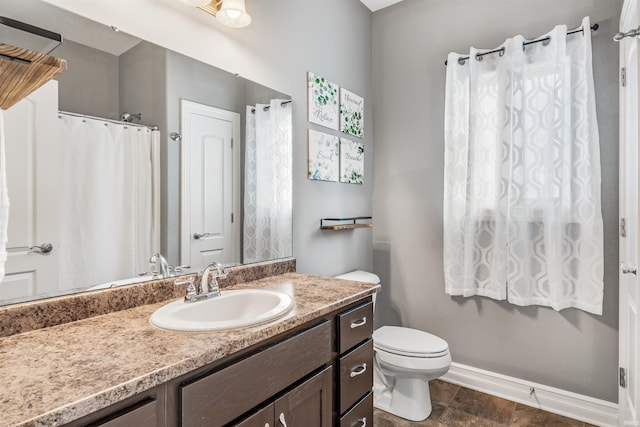 bathroom featuring toilet and vanity