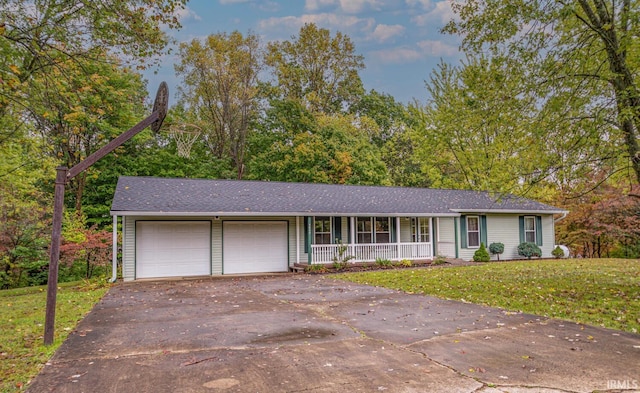 single story home featuring a front yard, a garage, and a porch