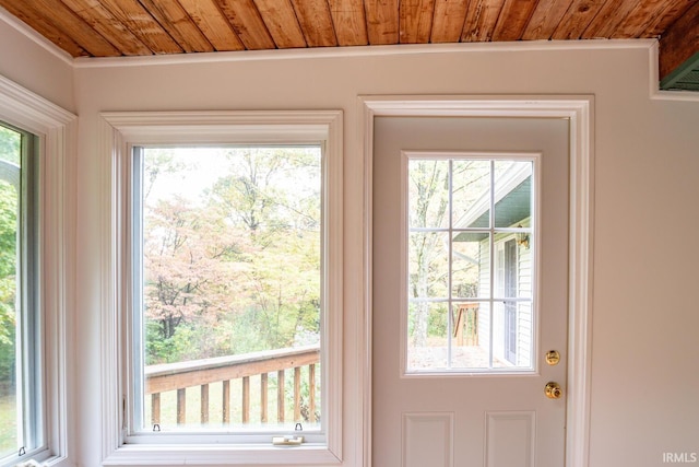 entryway featuring a wealth of natural light, ornamental molding, and wooden ceiling