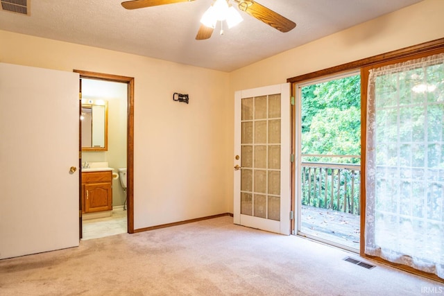 unfurnished room featuring ceiling fan and light colored carpet