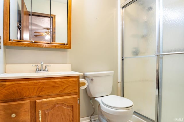 bathroom with toilet, ceiling fan, walk in shower, and vanity