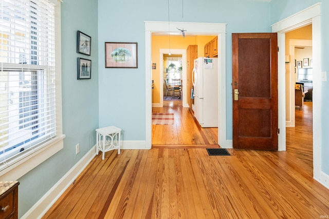 hallway with light wood-type flooring