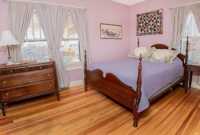 bedroom featuring light hardwood / wood-style floors and multiple windows