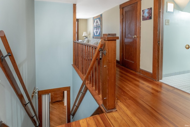 stairs with hardwood / wood-style floors