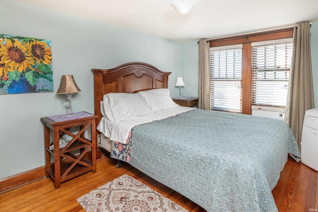 bedroom with hardwood / wood-style flooring