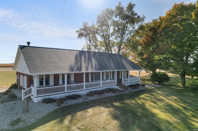 view of front of home with a front yard and covered porch