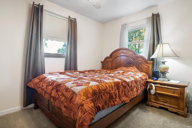 bedroom featuring ceiling fan and carpet
