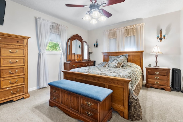 bedroom featuring ceiling fan and light carpet