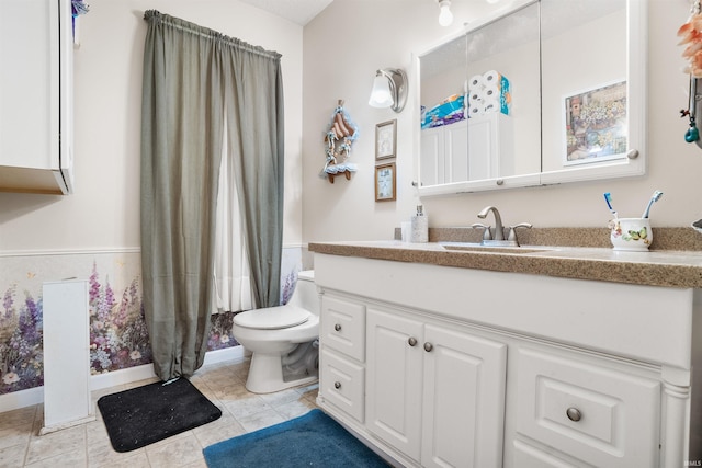 bathroom featuring tile patterned floors, toilet, and vanity