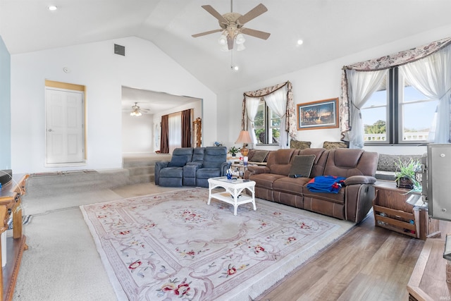 living room featuring ceiling fan, light hardwood / wood-style flooring, and vaulted ceiling