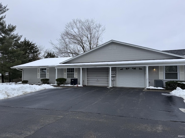 view of front of home featuring a garage and central AC unit