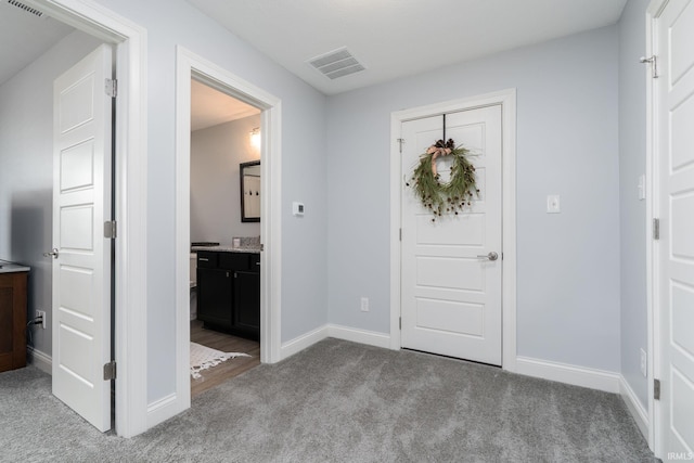 view of carpeted foyer entrance