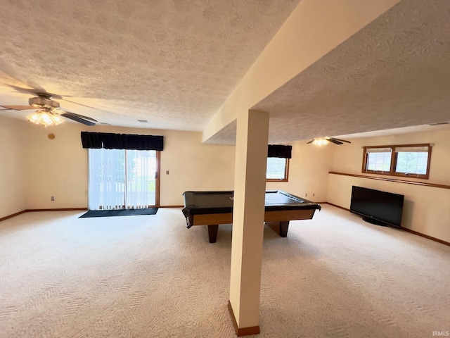 rec room with light carpet, billiards, ceiling fan, and a textured ceiling