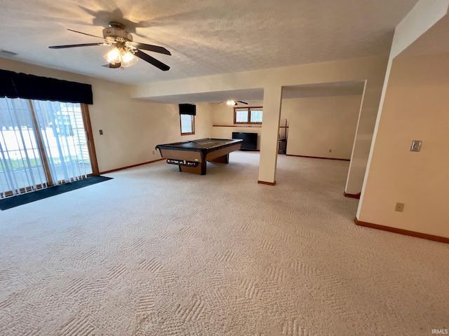 rec room with ceiling fan, billiards, light carpet, and a textured ceiling