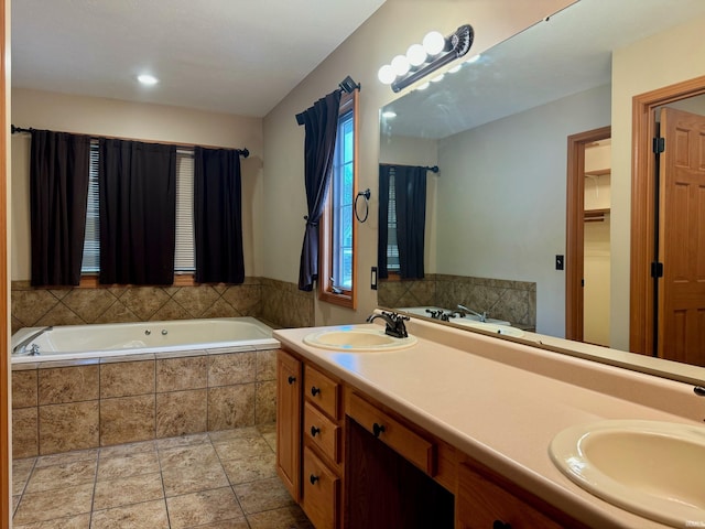 bathroom with vanity and tiled tub