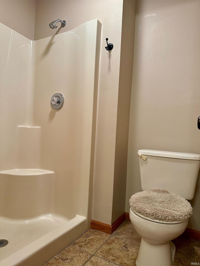 bathroom with toilet and a shower