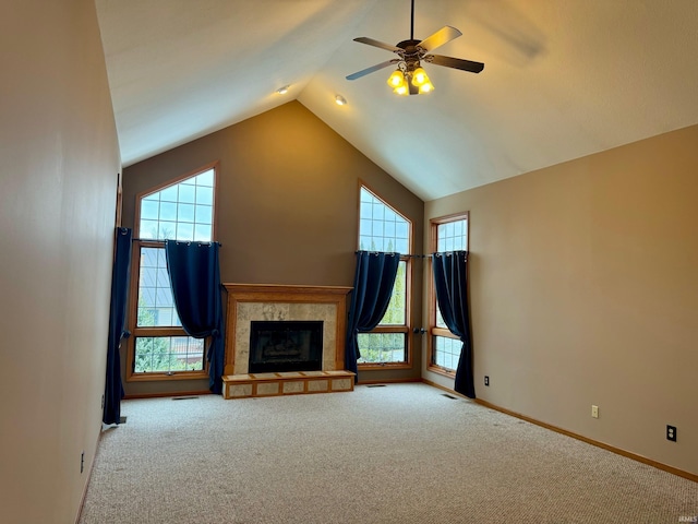 unfurnished living room featuring vaulted ceiling, ceiling fan, light colored carpet, and a tile fireplace