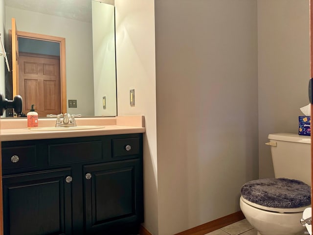 bathroom featuring toilet, vanity, and tile patterned floors